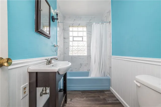 an empty room with wooden floor and window