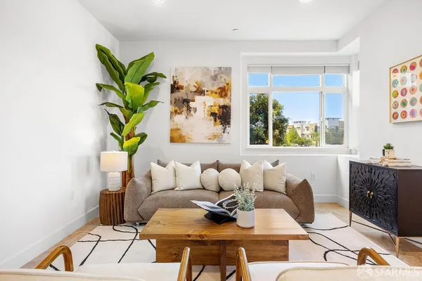 a living room with furniture and a potted plant