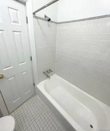 a spacious bathroom with a bathtub and a shower