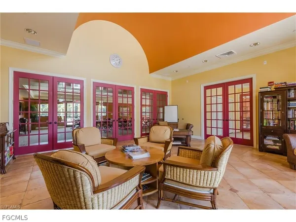 a living room with furniture a flat screen tv and large window