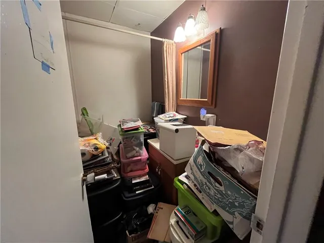 a bedroom with bed and wooden floor