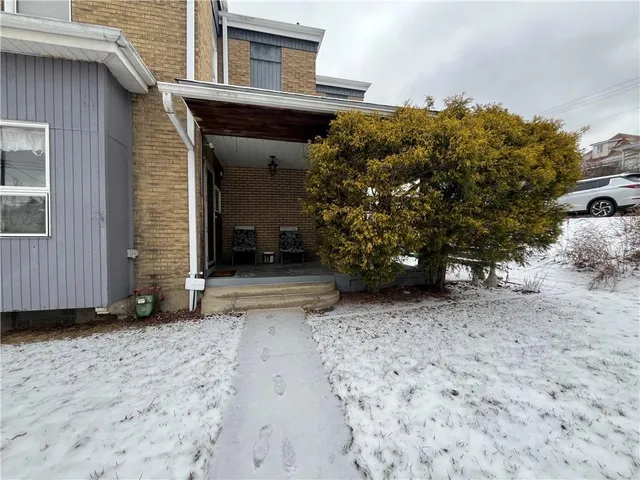 a view of a house with a tree