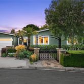 a front view of a house with a yard and a garden