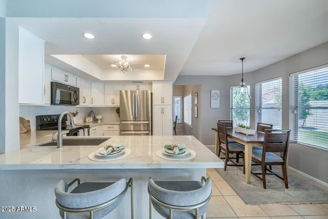 a kitchen with stainless steel appliances a refrigerator and a stove top oven