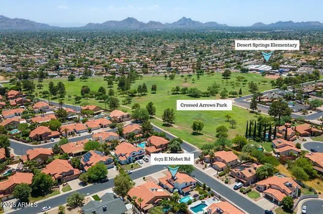an aerial view of residential houses with outdoor space