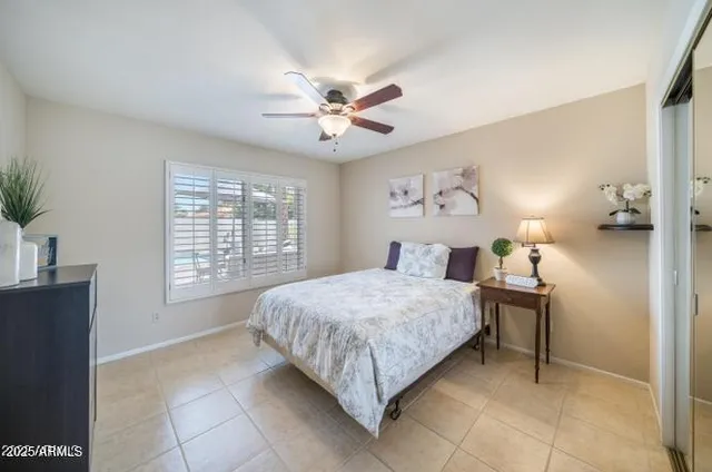 a view of a livingroom with a ceiling fan and window