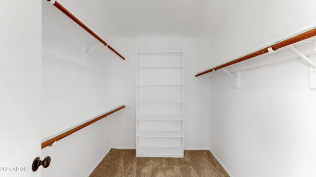 a spacious bathroom with a double vanity sink a mirror and a bathtub