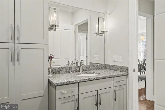 a bedroom with a bed a flat screen tv and a couch