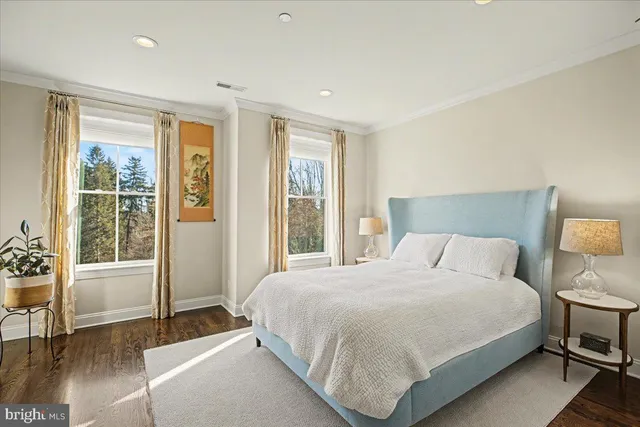 a bedroom with a bed and a television