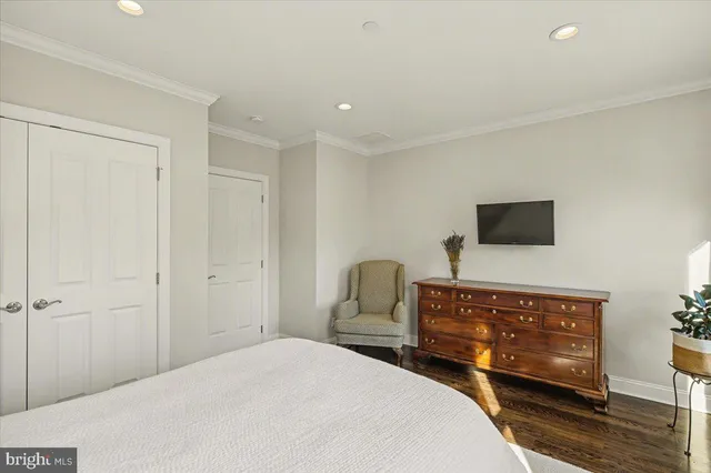 a bedroom with furniture and a window