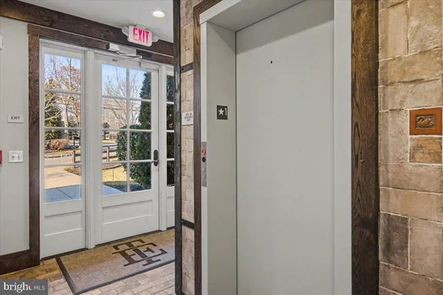 a view of entryway with wooden floor and stairs