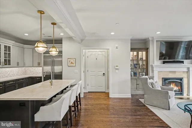a view of a kitchen with granite countertop a stove top oven a sink dishwasher with a dining table and chairs