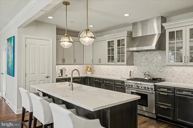 a kitchen with a kitchen island a sink stainless steel appliances and cabinets