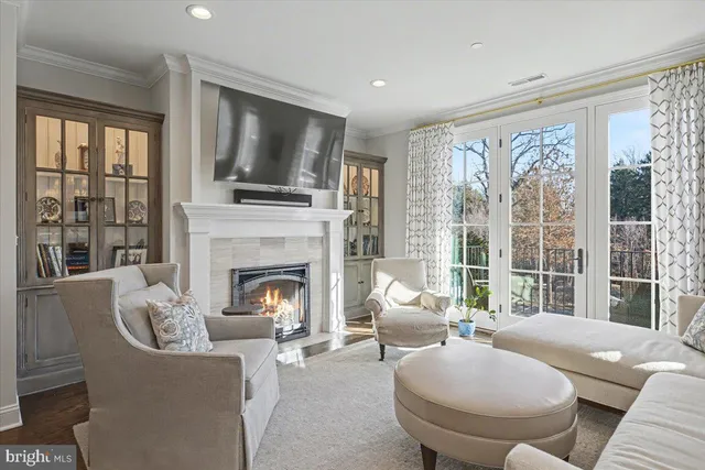 a living room with furniture a large window and a fireplace