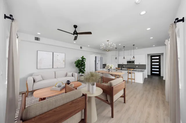 a living room with furniture and kitchen view