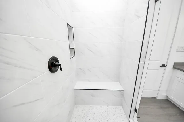 a view of a white house with a yard and a large tree