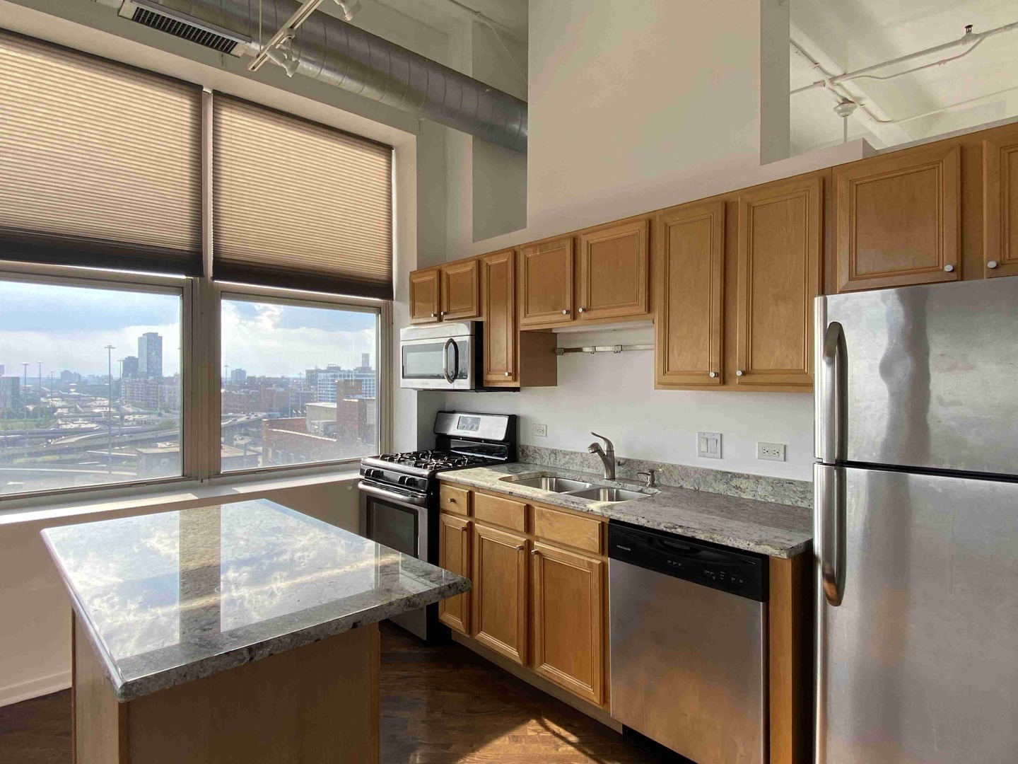 500 South Clinton Street, Unit 1017 Chicago, IL 60607 - Photo 6 of 11 a kitchen with a sink stove and refrigerator