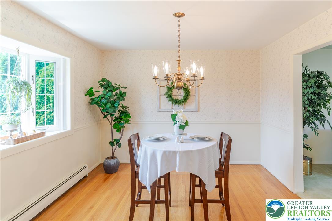 2130 Wisteria Road Lower Macungie Township, PA 18062 - Photo 13 of 48 A quaint dining area bathed in natural light features polished wood flooring and a classic chandelier.