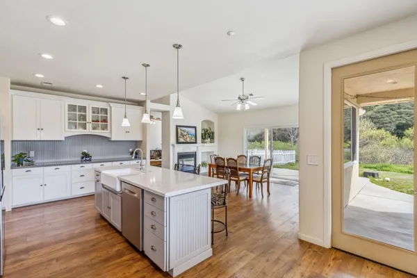 a large kitchen with kitchen island a large island in the center and stainless steel appliances