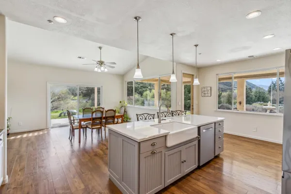 a large white kitchen with a large window