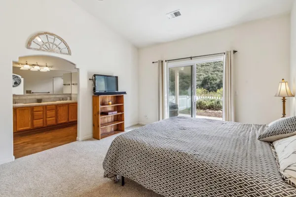 a bedroom with a bed and a large window