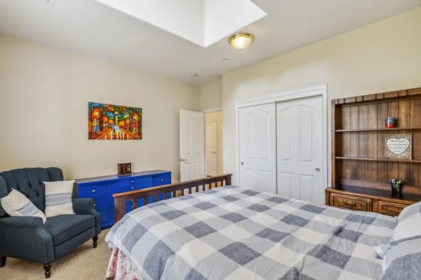 a bedroom with a bed and a couch