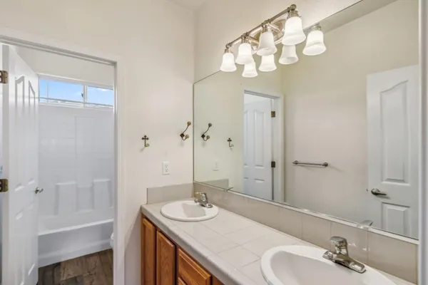 a bathroom with a sink a mirror and a shower