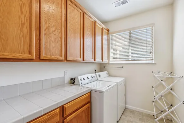 a utility room with a sink washer and dryer