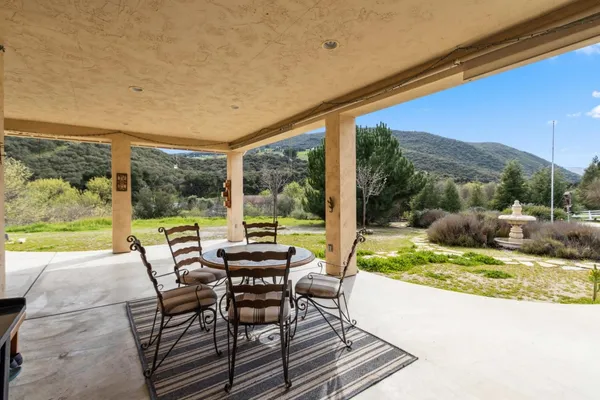 a view of a house with backyard and porch