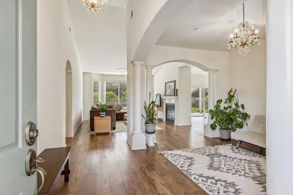 a living room with furniture flowerpot and wooden floor