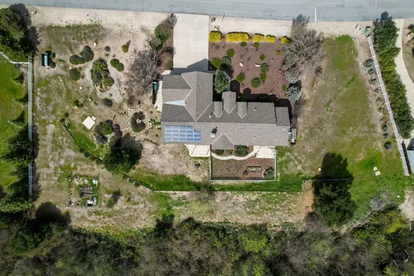 an aerial view of a house with a yard