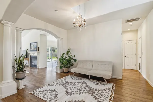 a living room with furniture and a potted plant