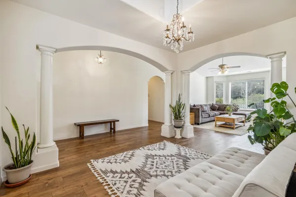 a living room with furniture and a chandelier