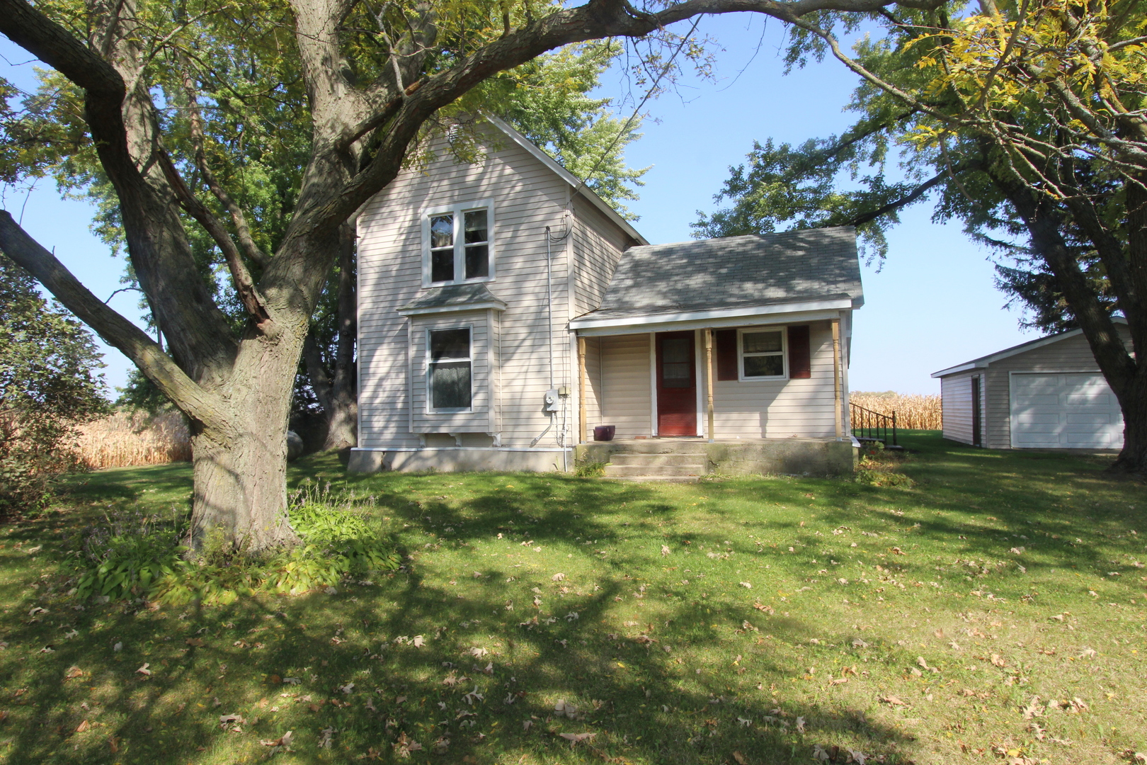 10714 Vanderkarr Road Hebron, IL 60034 - Photo 1 of 17 a front view of a house with a garden