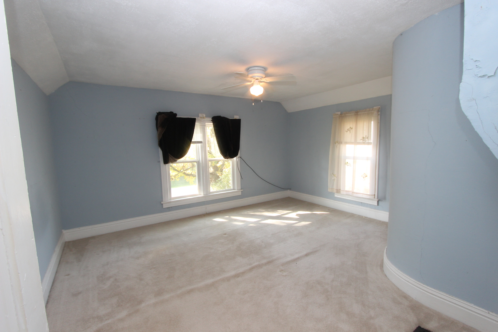 10714 Vanderkarr Road Hebron, IL 60034 - Photo 17 of 17 an empty room with windows and chandelier fan