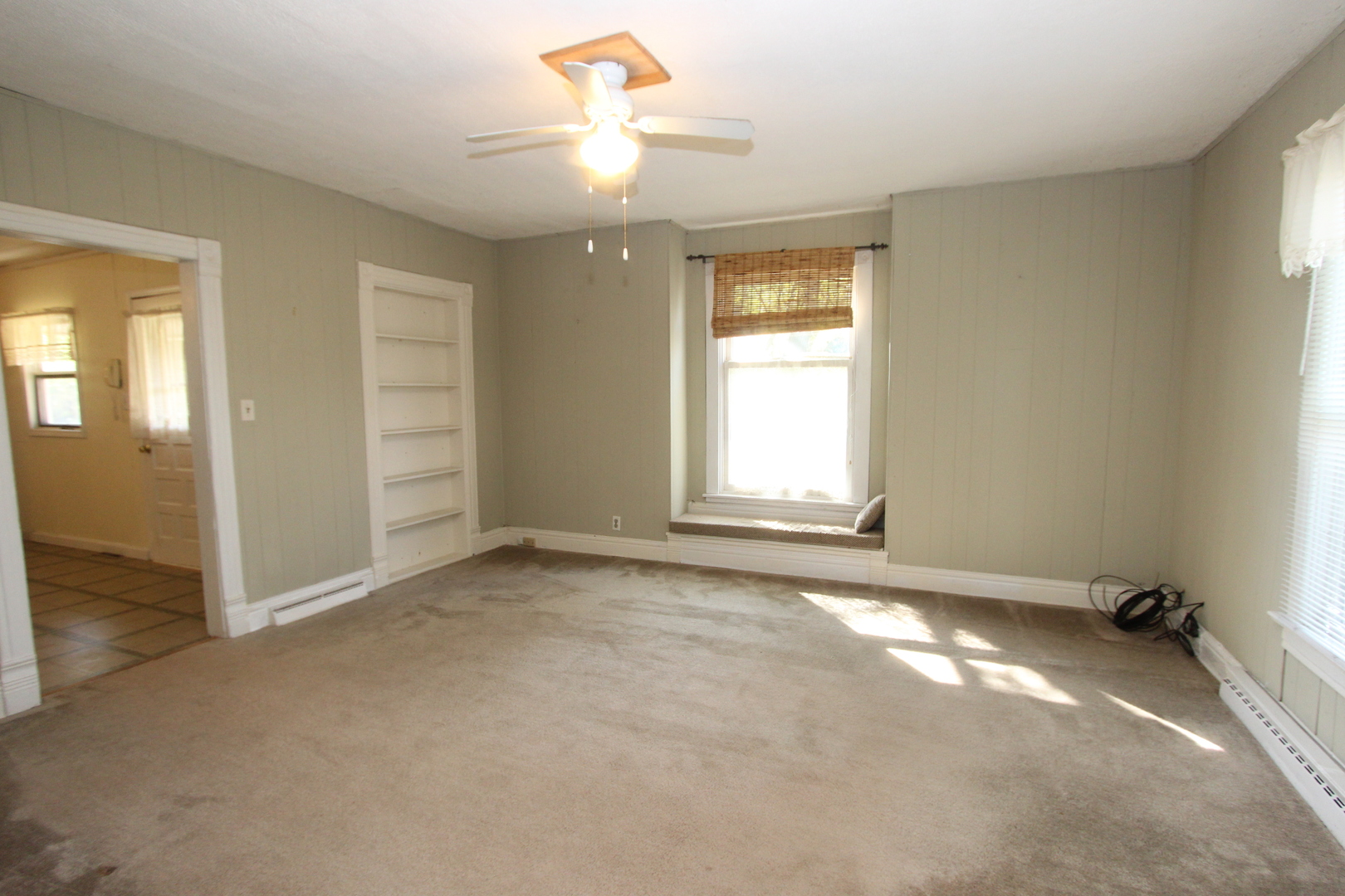 10714 Vanderkarr Road Hebron, IL 60034 - Photo 9 of 17 an empty room with windows and ceiling fan