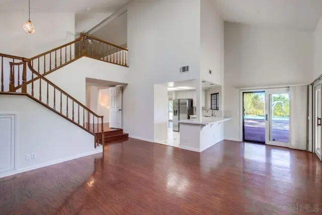 a view of an entryway with wooden floor