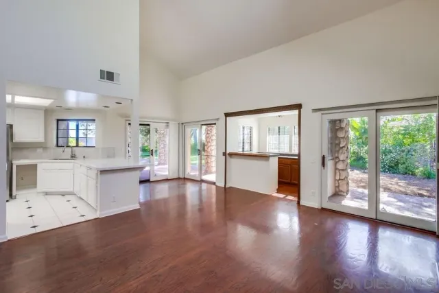 a view of a living room with hardwood floor and a large window