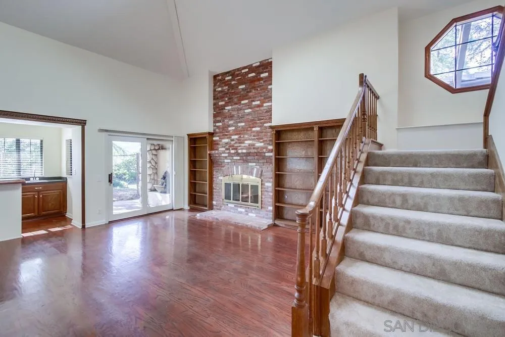 15235 Crestview Court Poway, CA 92064 - Photo 15 of 68 a view of an entryway with wooden floor leading to a furnished livingroom and windows