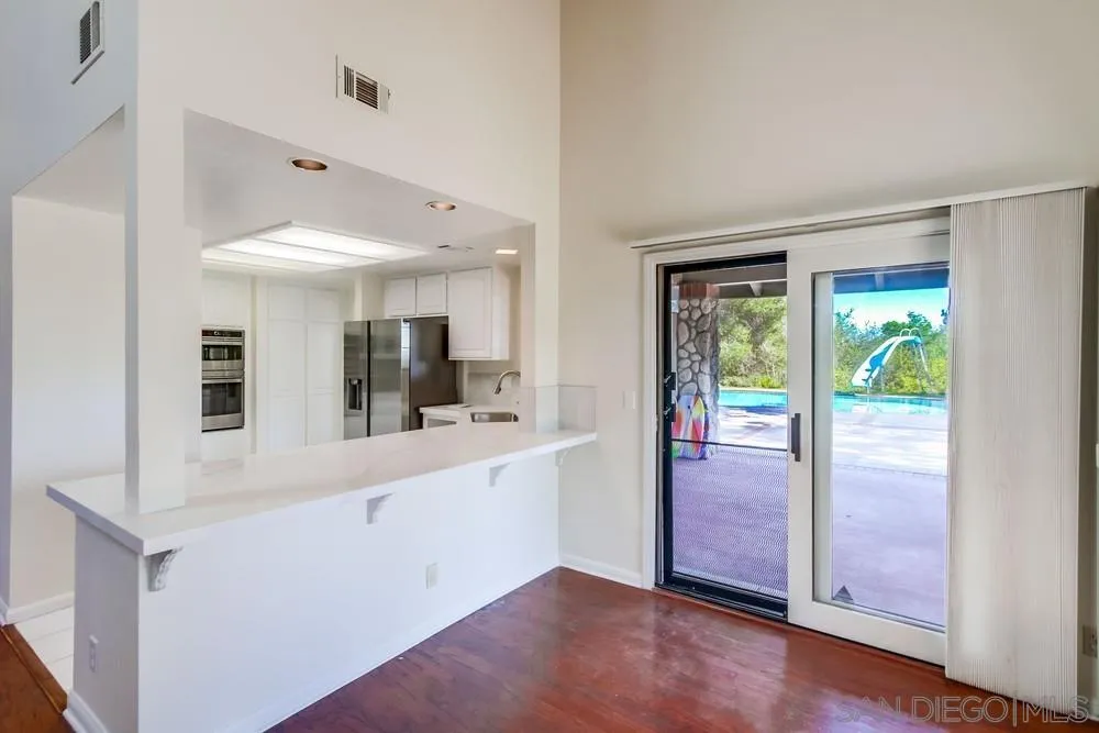 15235 Crestview Court Poway, CA 92064 - Photo 18 of 68 a view of a living room with hardwood floor and a large window