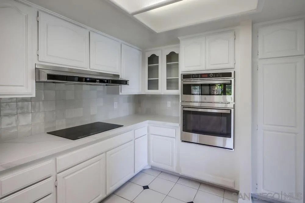 15235 Crestview Court Poway, CA 92064 - Photo 21 of 68 a kitchen with stainless steel appliances granite countertop white cabinets and sink