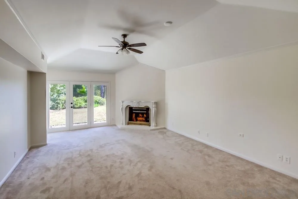 15235 Crestview Court Poway, CA 92064 - Photo 25 of 68 a view of an empty room with a fireplace and a window