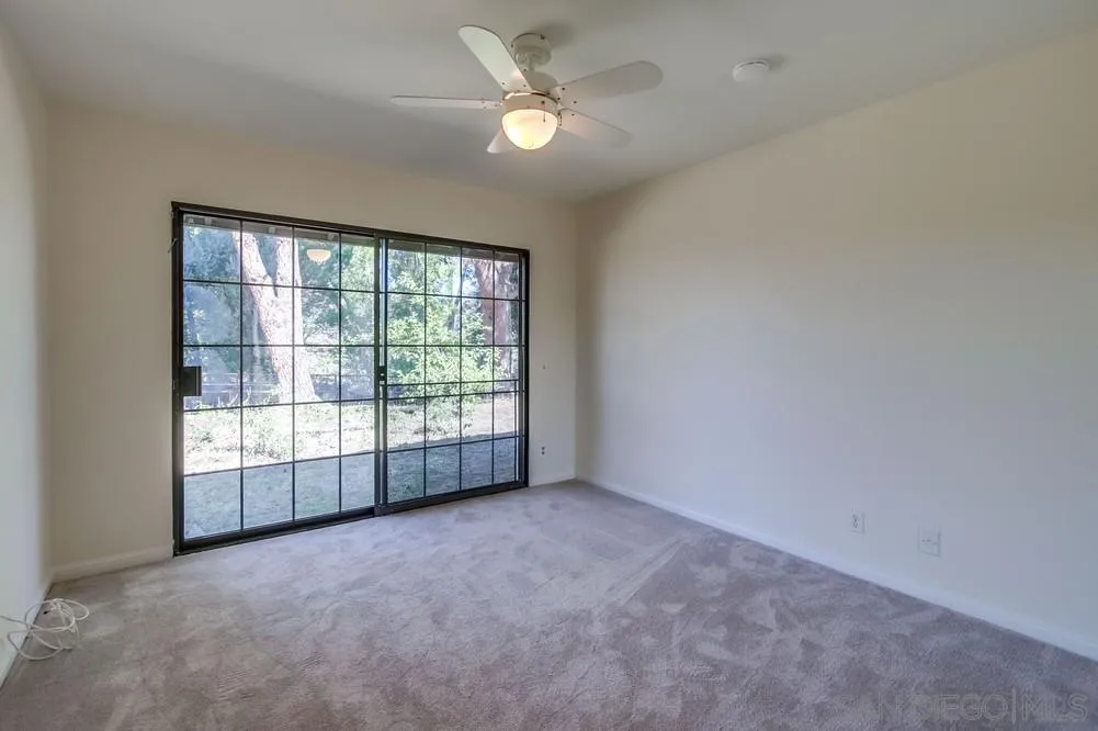 15235 Crestview Court Poway, CA 92064 - Photo 34 of 68 an empty room with chandelier fan and windows