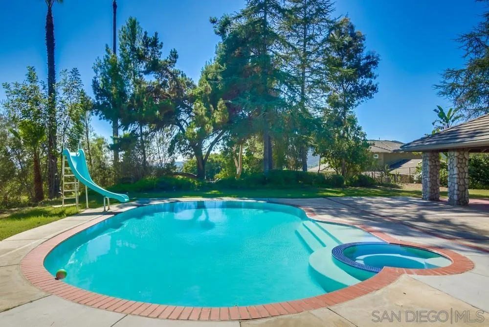 15235 Crestview Court Poway, CA 92064 - Photo 47 of 68 a view of a swimming pool with a yard