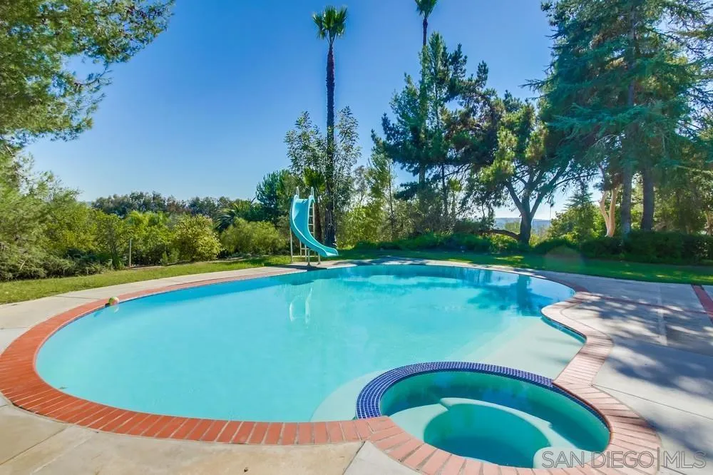 15235 Crestview Court Poway, CA 92064 - Photo 48 of 68 a view of a swimming pool with a yard and trees