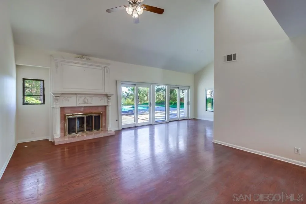 15235 Crestview Court Poway, CA 92064 - Photo 7 of 68 a view of an empty room with wooden floor and a window
