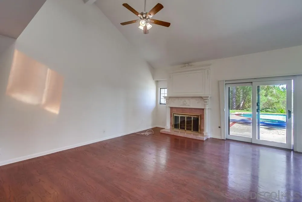 15235 Crestview Court Poway, CA 92064 - Photo 10 of 68 wooden floor fireplace and natural light in room