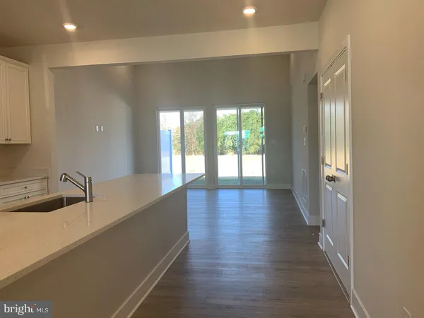 a view of a room with wooden floor and a sink