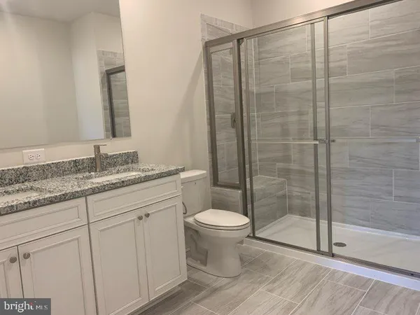 a white toilet sitting next to a white sink
