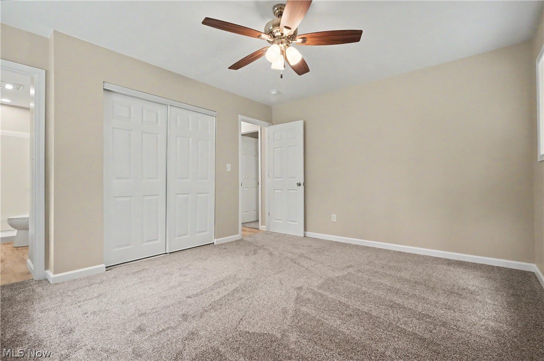 7583 Yale Road Atwater, OH 44201 - Photo 25 of 41 First floor primary bedroom features brand new ceiling fan, paint, carpet, man door, closet door, and windows.
